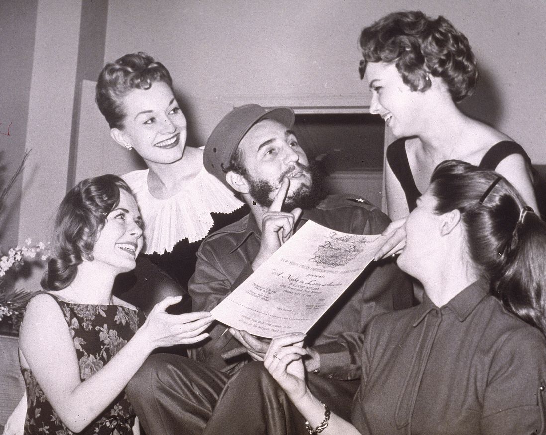 Cuban leader Fidel Castro is presented with an invitation to the New York Press Photographer's Ball, New York City, April 23, 1959.  (Hulton Archive / Getty)